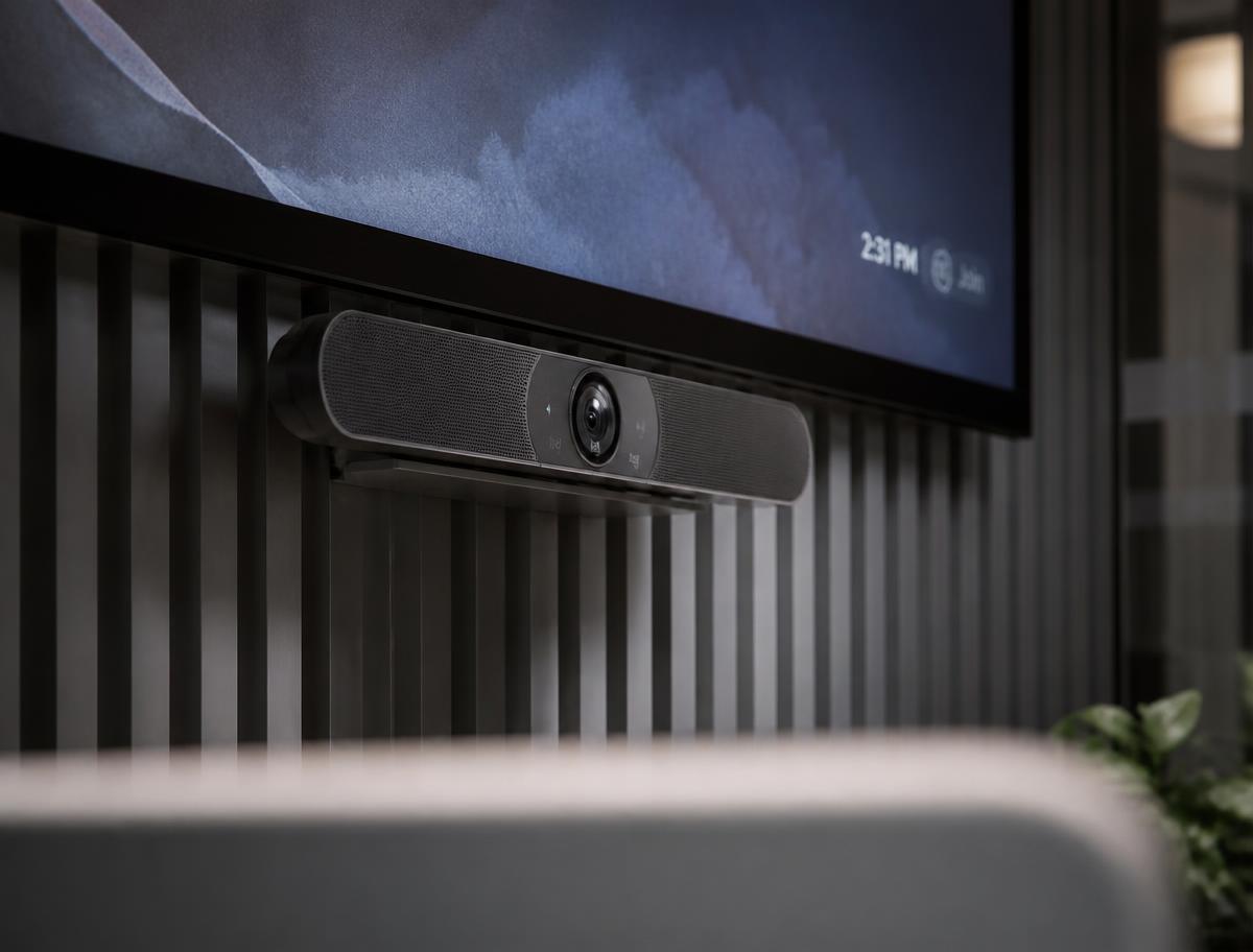 Professional conferencing camera bar mounted beneath a large commercial display in a meeting room